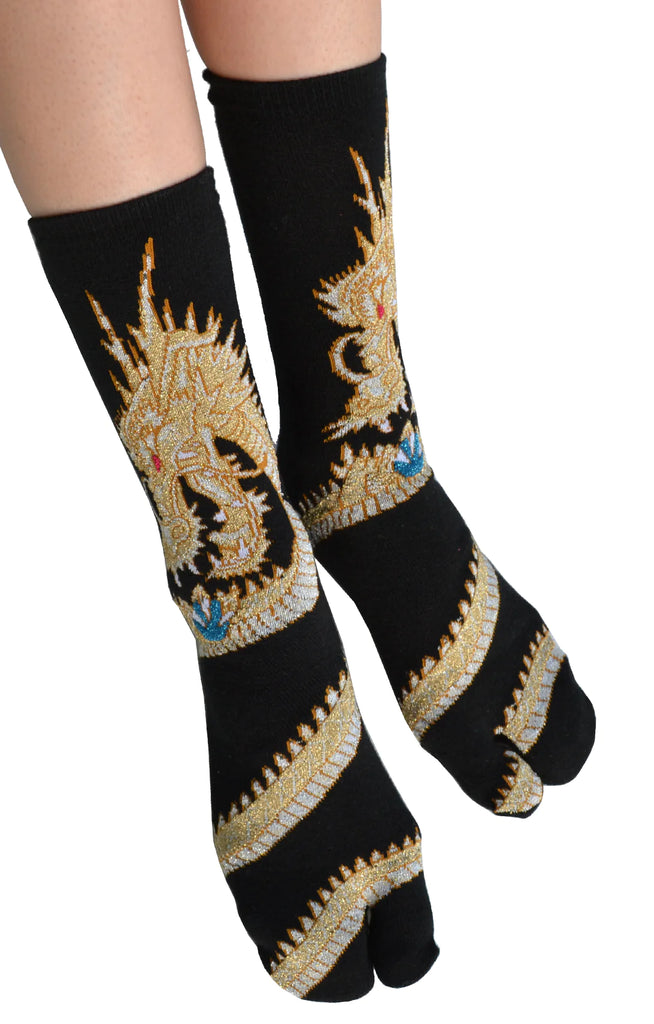 Photo of a leg of a woman wearing the product name DRAGON TABI SOCKS Gold with dragon design of NINJA SOCKS