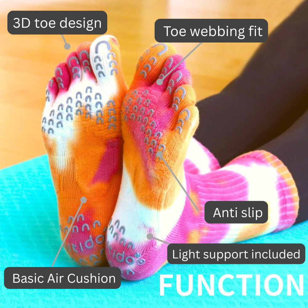 Colorful yoga socks with foot design and text labels on a blurred background.