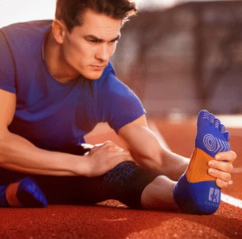 Man wearing marathon socks at the racing track.