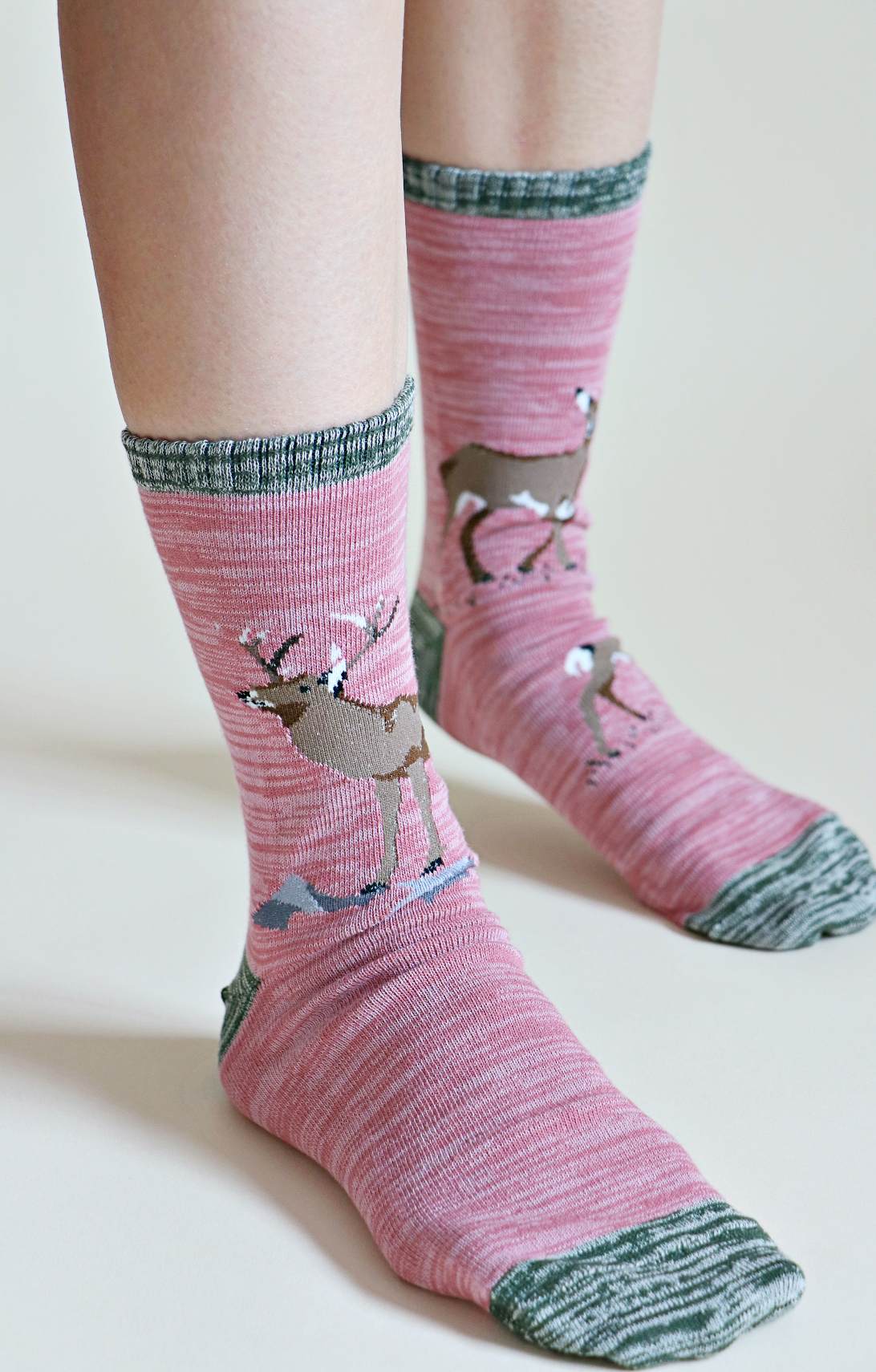TABBISOCKS brand Replant Pairs Deer Organic Cotton Crew Socks in Rose color with grayish green deer pattern on the heel, toe and foot.