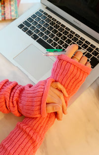 Woman's arm typing in Tabbisocks' Wool Blend Ribbed Arm Warmer in pink