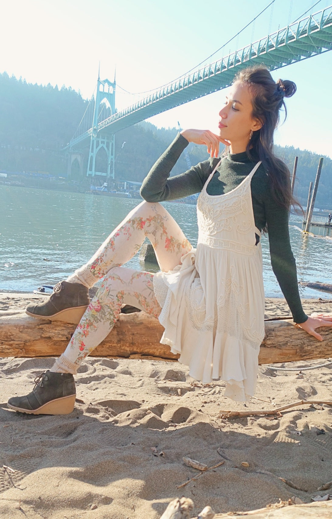 Woman is sitting by the river, wearing antique flower tights.