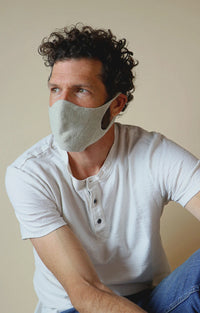 Man wearing white polo shirt with Tabbisocks Wellness Botanical Dyed Organic Cotton Face Mask in Aqua
