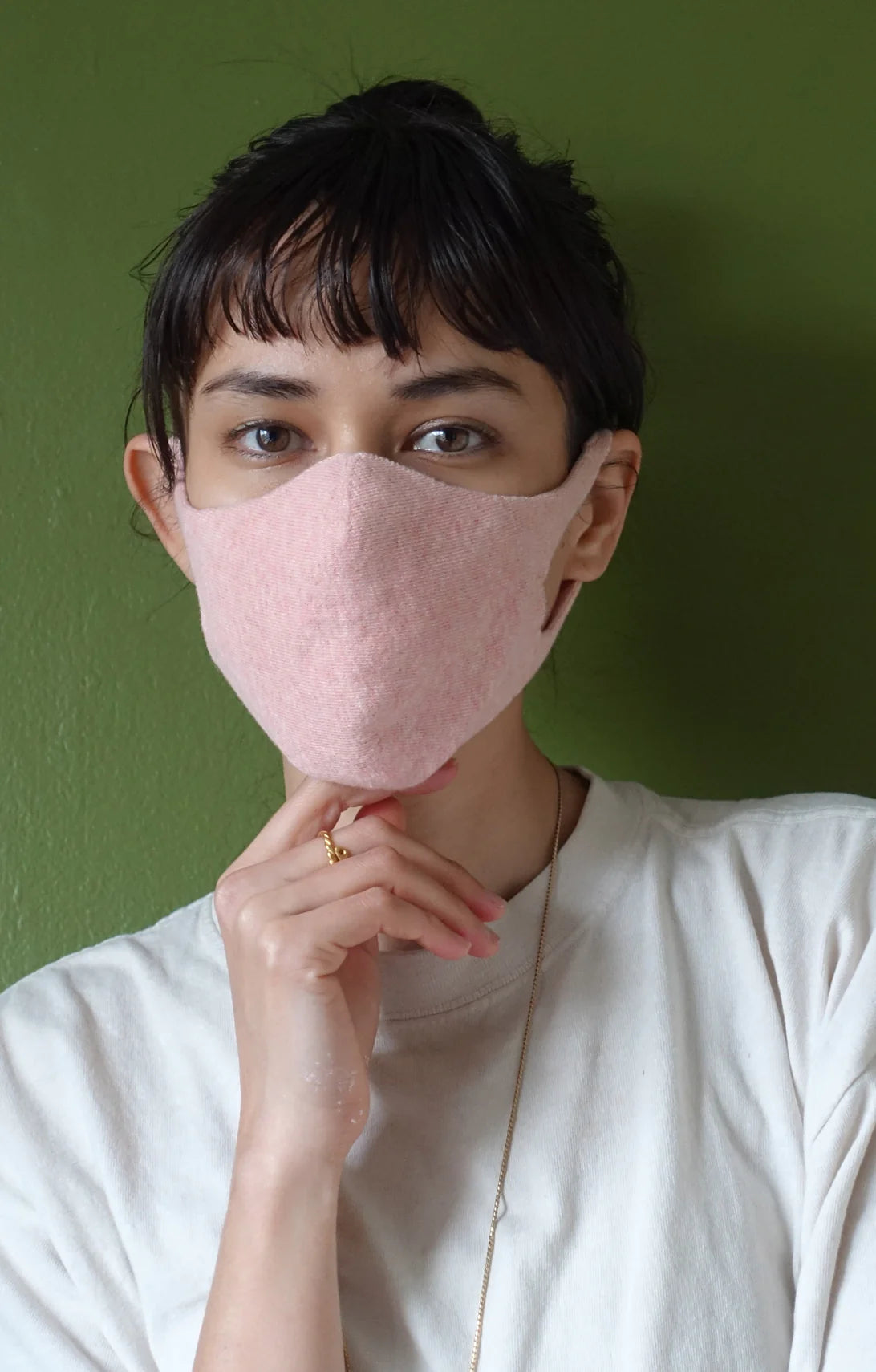 Woman in white T-shirt wearing pink Botanical Dyed Organic Cotton Face Mask from Tabbisocks Wellness