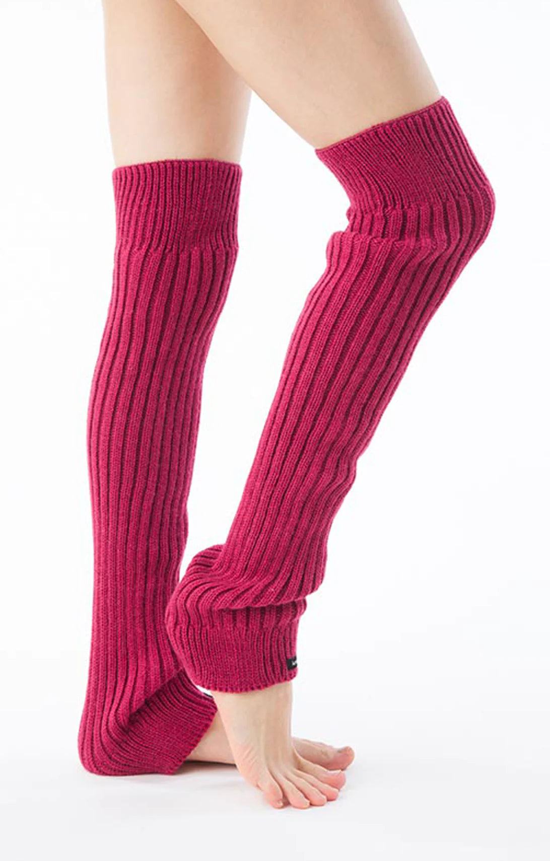 Side view of a woman's leg wearing the Fuchsia Pink color of the Knitido plus brand Wool Blend Ribbed Leg Warmer product