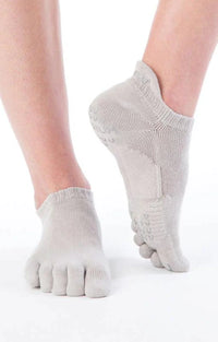Image of a foot wearing Knitido plus's Basic Solid Colors Footie Grip Toe Socks With Power Pads in the color Grey