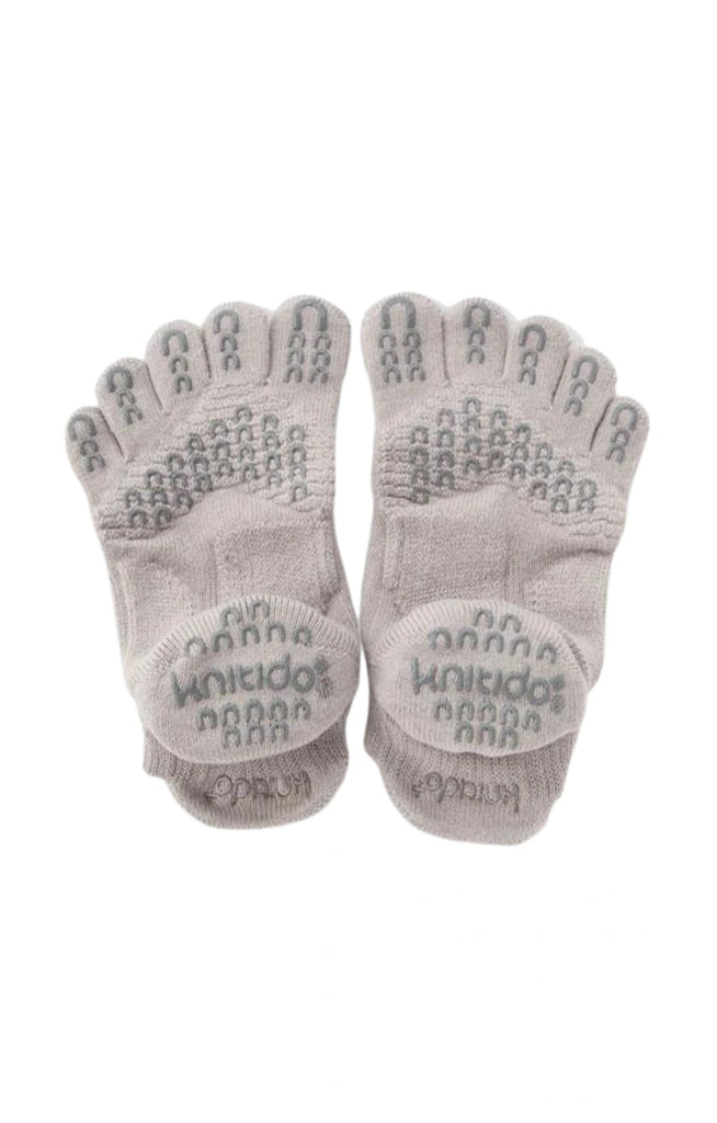 The back of Knitido plus's Basic Solid Colors Footie Grip Toe Socks With Power Pads in Grey