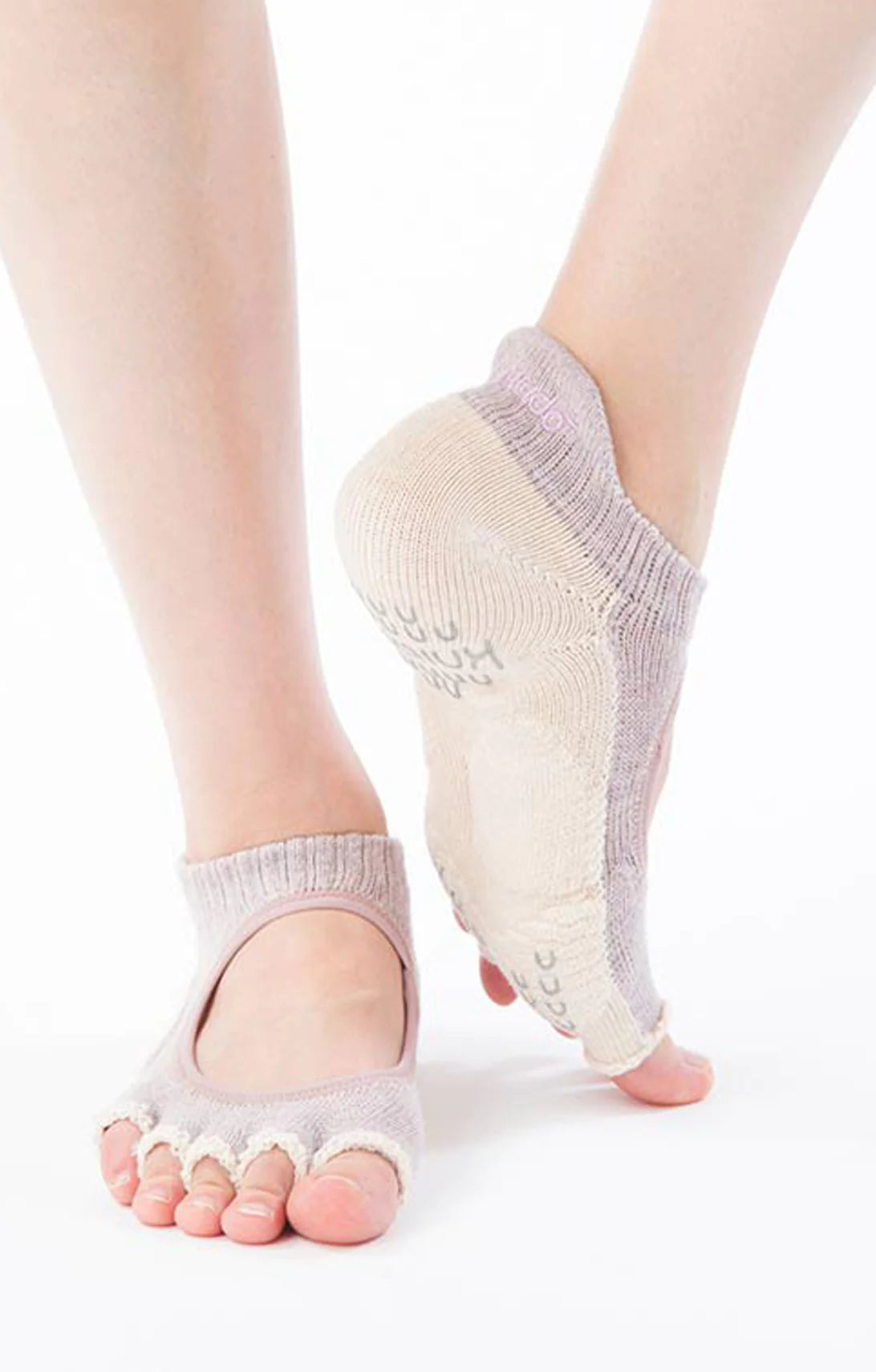 Woman's leg wearing Knitido plus Botanical Dyed Open Toe Footie Grip Socks With Power Pads in Purple