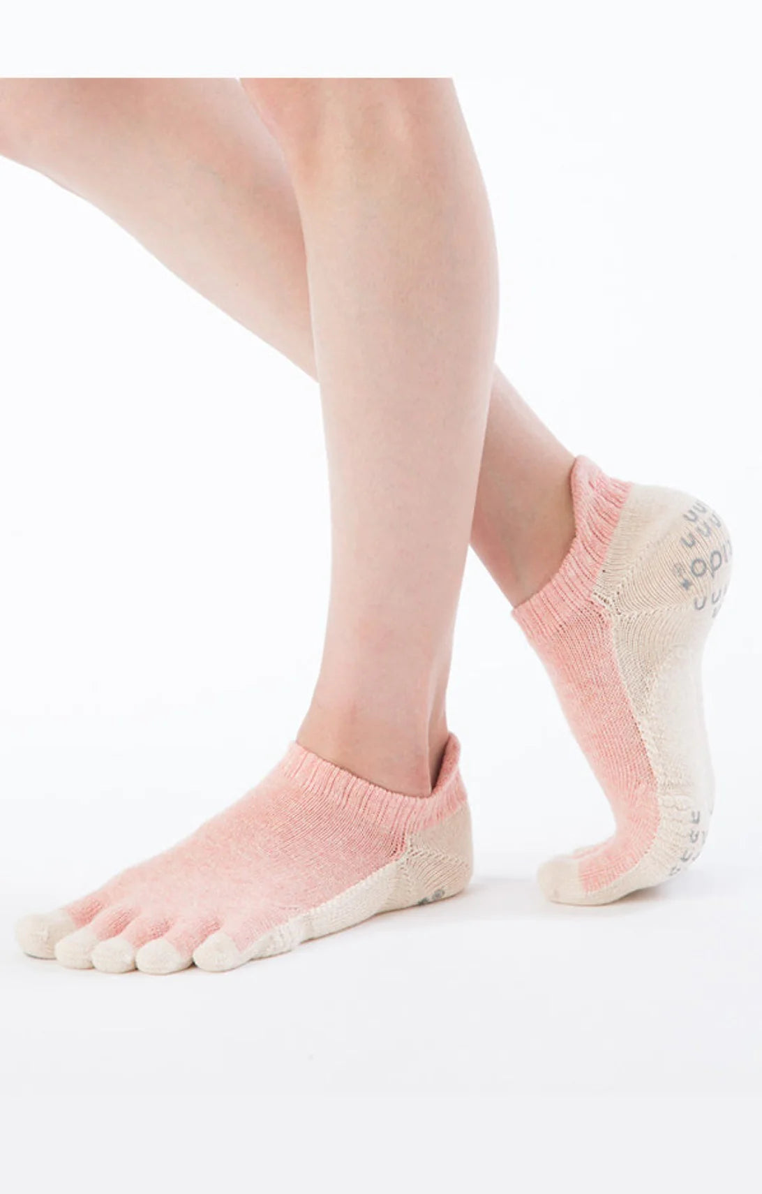 Side view of a woman's leg wearing Knitido plus Botanical Dyed Pilates Grip Toe Socks With *Power Pads* in PINK