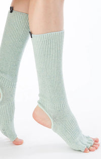 This is a side view of the Organic Cotton Botanical Dyed Open Toe/Heel Grip Socks in Mint from the brand Knitido+Side view of a woman's leg wearing Knitido plus brand Organic Cotton Botanical Dyed Open Toe and Heel Grip Socks in Mint color