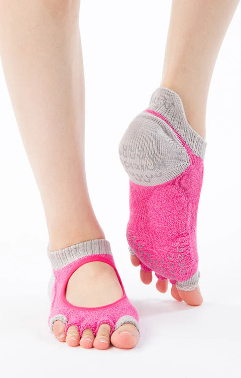 This is a photo of a woman's leg wearing the brand name Knitido+ product TWO COLORS OPEN GRIP TOE FOOTIE *POWER PADS* SOCKS in the color Pink