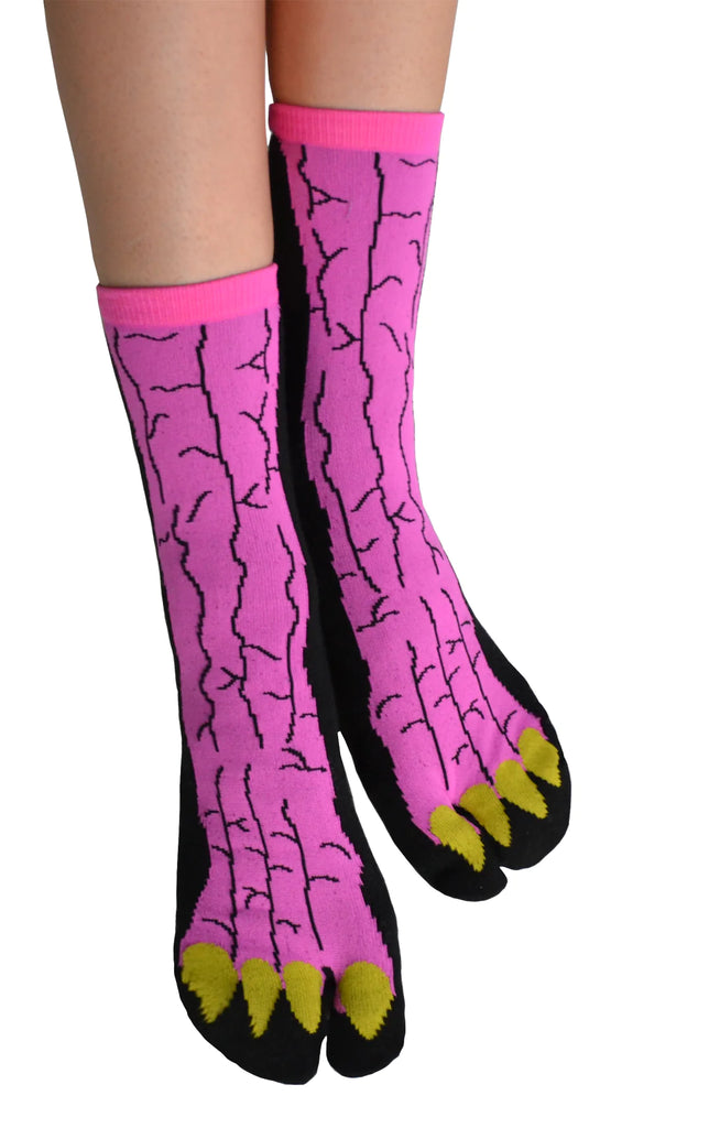 This is a photo of a woman's leg wearing a pair of NINJA SOCKS GODZILLA TABI SOCKS Black, a product name for the Japanese monster movie Godzilla