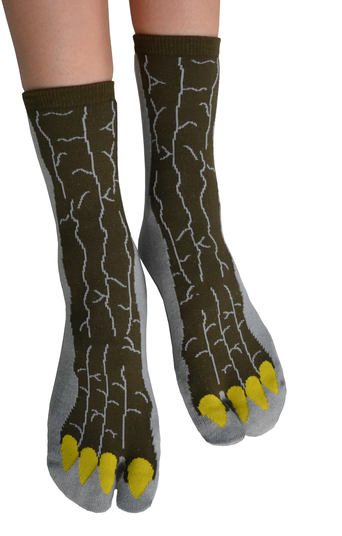 This is a photo of a woman's leg wearing a pair of NINJA SOCKS GODZILLA TABI SOCKS Grey, a product name for the Japanese monster movie Godzilla