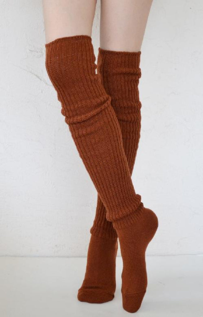 This is a photo of a woman's leg wearing Tabbisocks product name Scrunchy Over The Knee Lounge Wool Blend Socks Amber