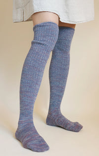 This is a photo of a woman's leg wearing Tabbisocks' product name Scrunchy Over The Knee Lounge Wool Blend Socks Purple Rose