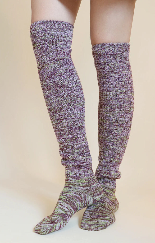This is a photo of a woman's leg wearing Tabbisocks' product name Scrunchy Over The Knee Lounge Wool Blend Socks Wine