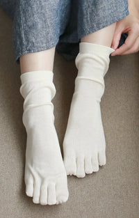 Female leg wearing Tabbisocks Washable 100%Silk Toe Liner Socks in Natural color