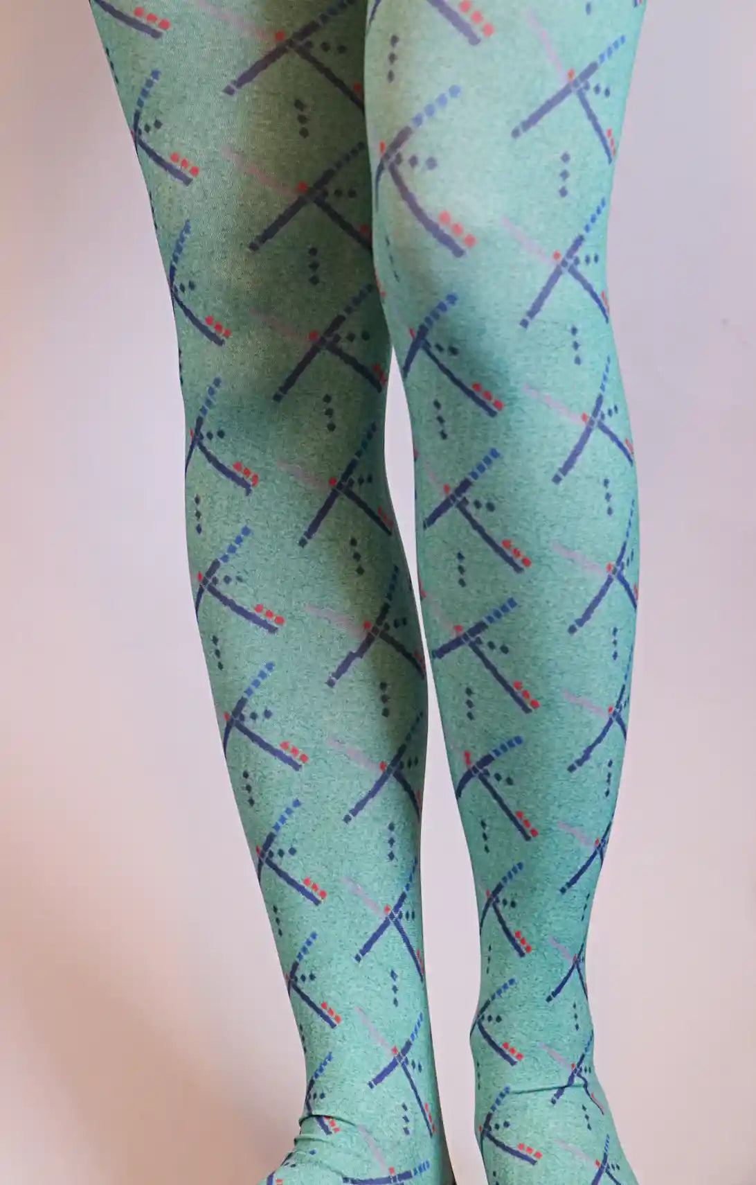 Woman is wearing PDX carpet designed green tights.