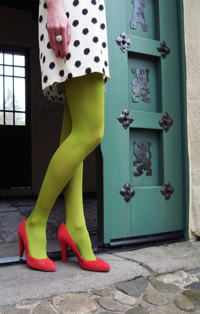 Tabbisocks 23 Colors Opaque Zokki Tights in bright yellow-greenish pear color worn with a black and white dotted dress and red high heels