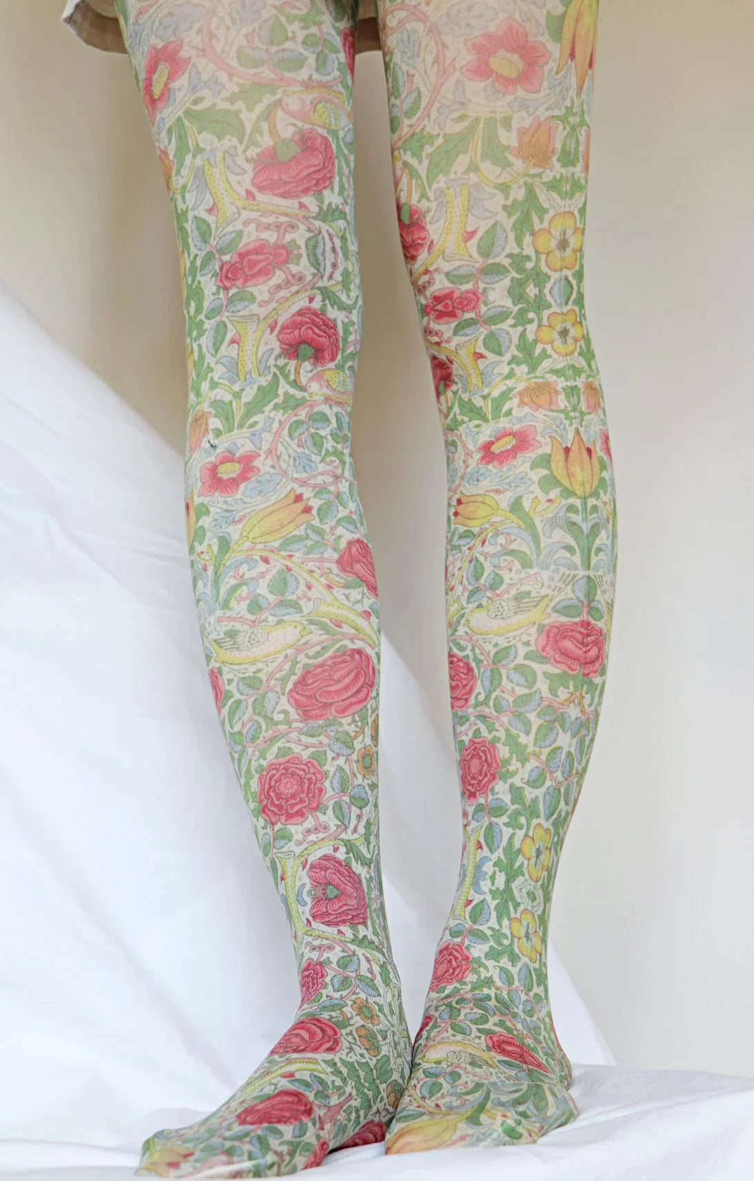 Woman's leg wearing Tabbisocks Bird And Rose By William Morris Printed Art Tights with red and yellow flower pattern
