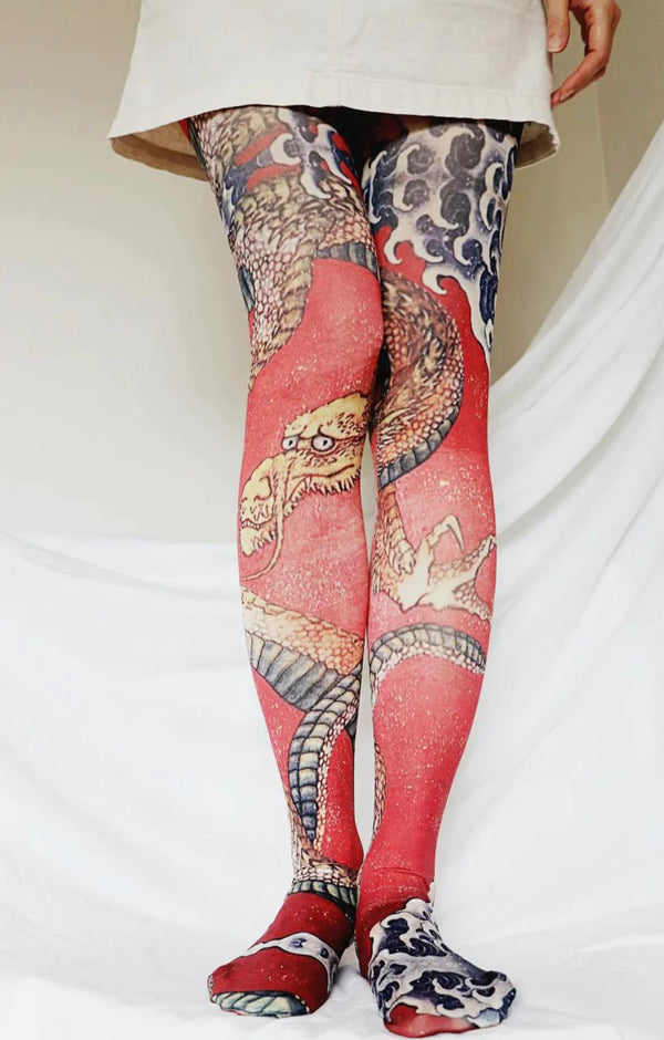 Front view of a woman's leg in ivory skirt wearing Tabbisocks Tights-Tabbisocks-Dragon-By-Katsushika-Hokusai-Printed-Art-Tights