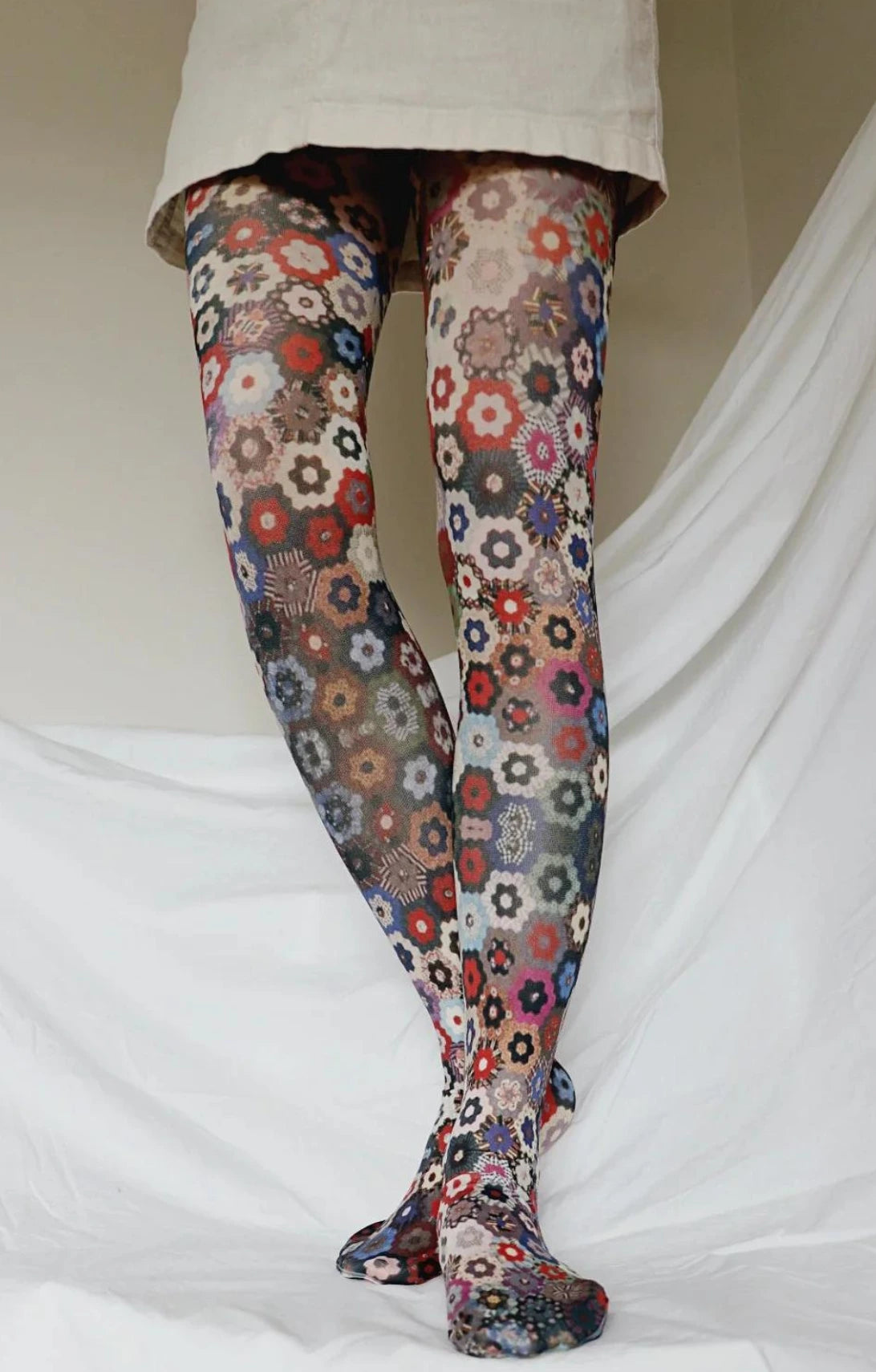 Woman's leg in cream skirt wearing Tabbisocks Honeycomb Quilt The Art Institute Of Chicago Printed Art Tights