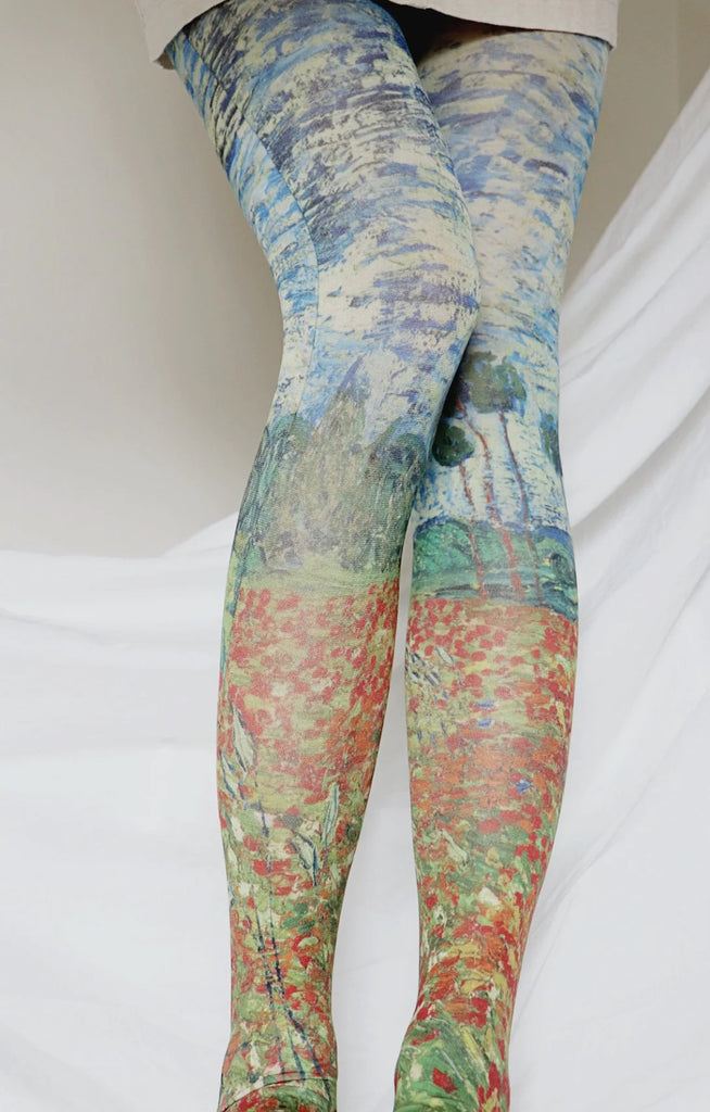 Close-up of a woman's leg in an ivory skirt wearing a pair of Tabbisocks Poppy field by Van Gogh Printed Art Tights