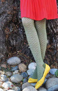 Photo of a woman in a red skirt and yellow pumps wearing Tabbisocks' trade name Zig Zag Comfortable Tights