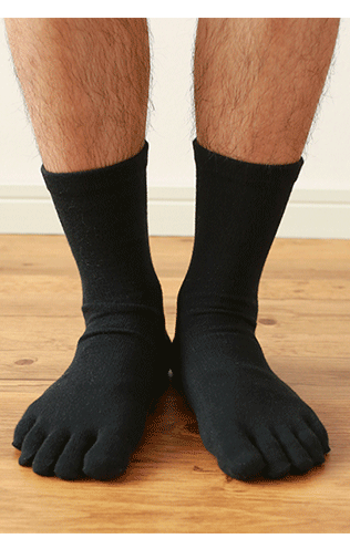 A man is wearing black toe socks.